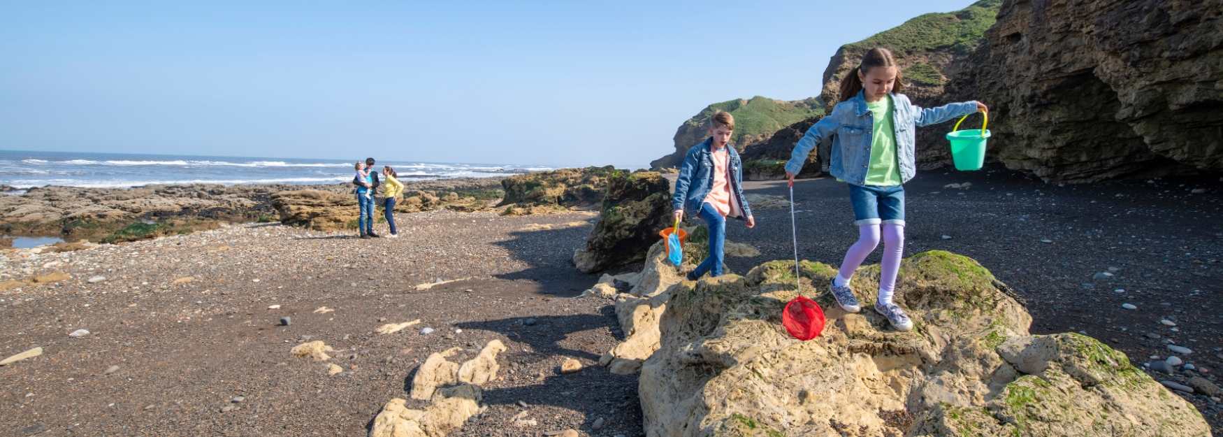 A family enjoying time on the beach at Blackhall Rocks