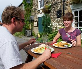 couple eating outdoors in a pub beer garden