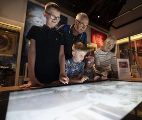 A family looking at an exhibition at the DLI Museum Durham