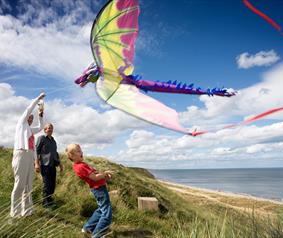 family flying a kite on the Durham Heritage Coast