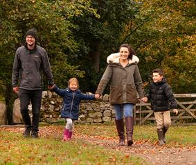 family walking through the Durham Dales during Autumn season. 