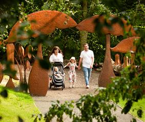 family walking through grounds at Durham University's Botanic Garden