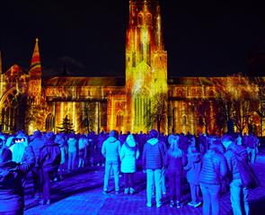 People outside of Durham Cathedral all lit up