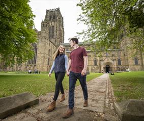 A couple walking at Durham Cathedral