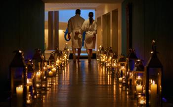 People walking at Seaham Hall spa surrounded by candles