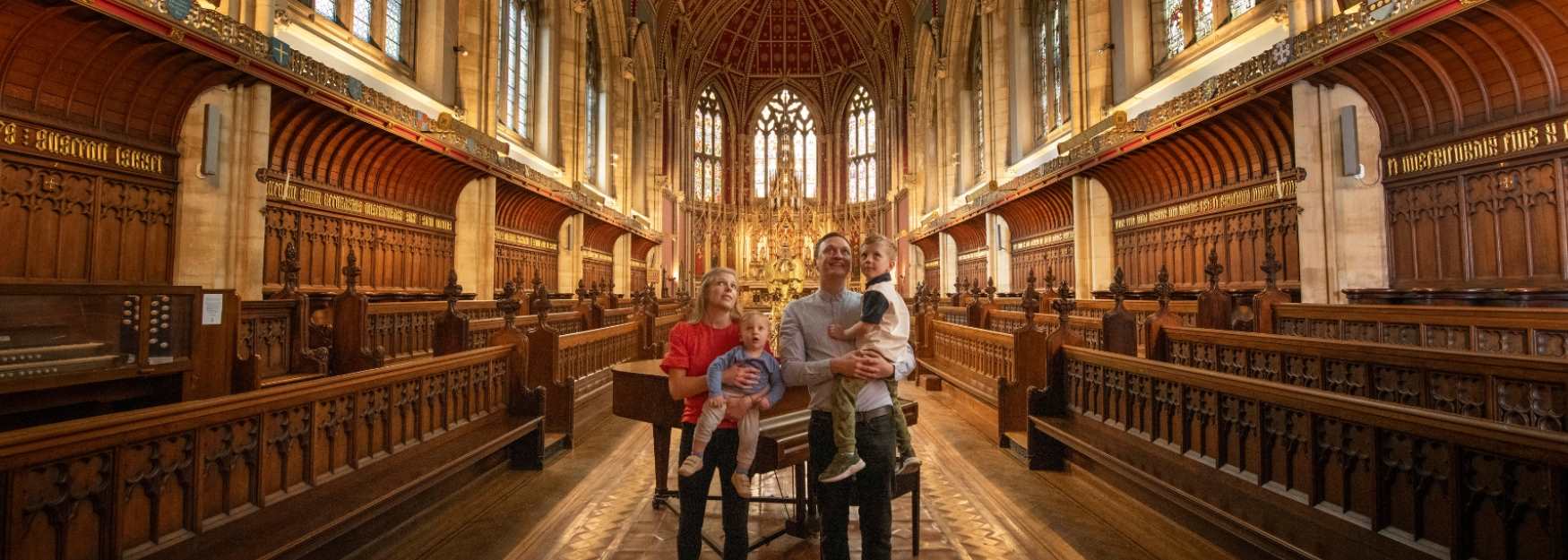 A family looking at the book shelves in Ushaw library