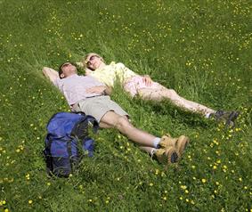 walkers lying in a hay meadow in County Durham.