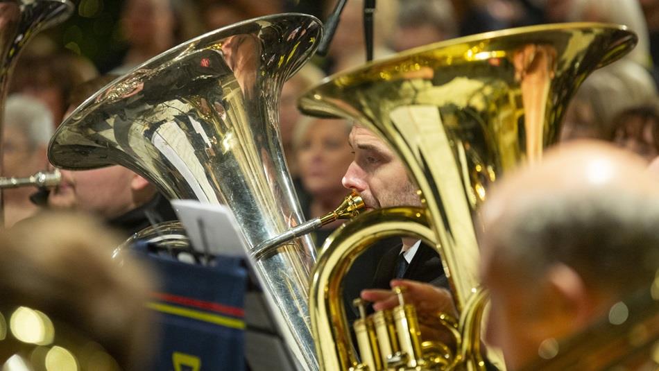 Close up view of people playing brass instruments. Close up view of people playing brass instruments.