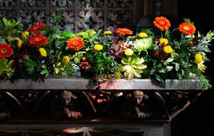 Flower display on a mantlepiece of a fireplace at Ushaw Historic House, Chapels and Gardens