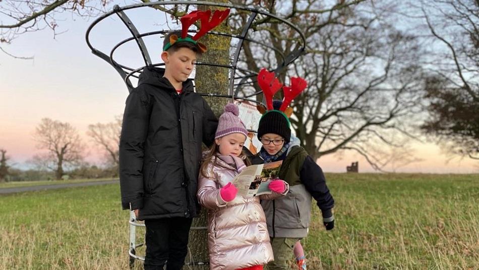 Children dressed in reindeer headbands enjoy a trail outdoors at Raby Castle.
