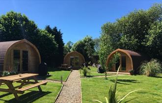 3 glamping pods in a field