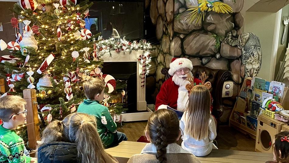 Children listening to Santa telling a story beside the Christmas Tree Children listening to Santa telling a story beside the Christmas Tree