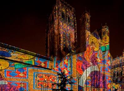 'Crown of Light' projection onto the façade of Durham Cathedral showing illuminated manuscripts from the Lindisfarne Gospels.