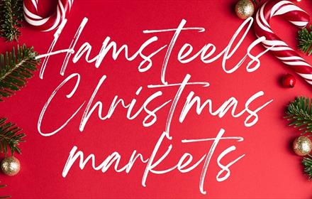 Hamsteels Christmas Market written in white on red background with Christmas decorations on edges.