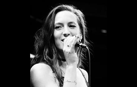 Black and white Image of Alice Grace singing on stage.
