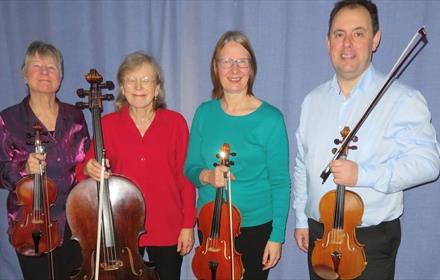 Photo of four string players in Aquarius Quartet.
