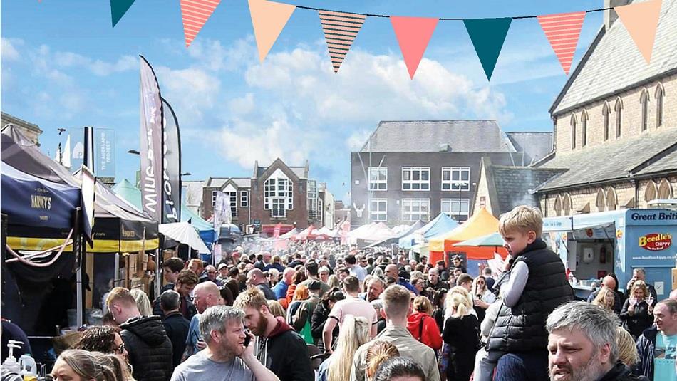 Crowds of people attending Bishop Auckland Food Festival, Market Stalls, bunting Crowds of people attending Bishop Auckland Food Festival, Market Stalls, bunting