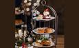 A three tier cake stand with cream cakes and scones, afternoon tea at Black Horse Beamish
