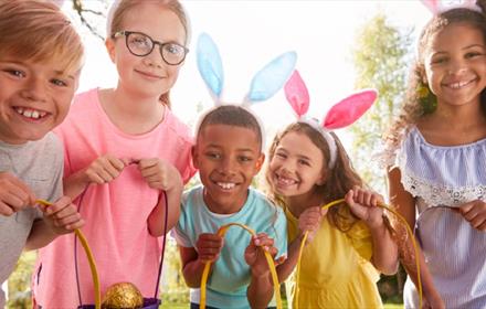 Children wearing Easter Bunny ears and holding baskets