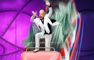Clinton Baptiste superimposed on to as rollercoaster full of spectres.