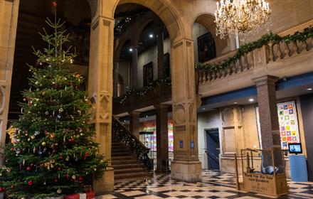 Image of large Christmas Tree and presents in The Bowes Museum.