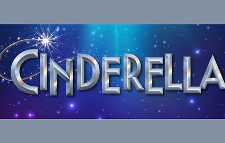 Cinderella written in silver on a blue starry background