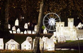 Lumiere art installation City lit up lanterns, some in the shape of houses, Durham Cathedral, bit wheel.