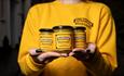 Holding 3 jars of Durham mustard in hands
