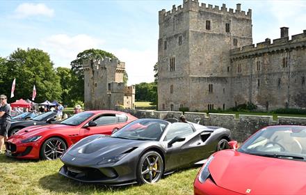 A selection of Italian cars parked in front of Raby Castle