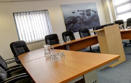 Conference room with tables and chairs set out in U shape