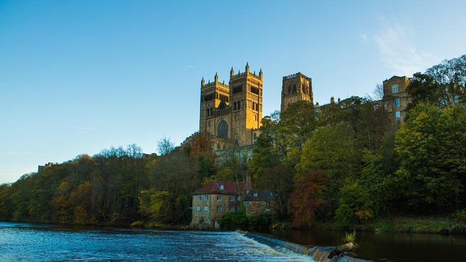 Durham Cathedral view from riverbank with river and woodland