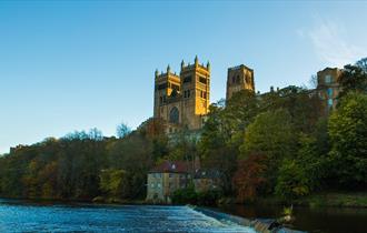 Durham Cathedral view from riverbank with river and woodland