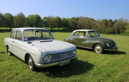 two examples of cars from a previous European Car Rally at Beamish Museum on the museum's Events Field.