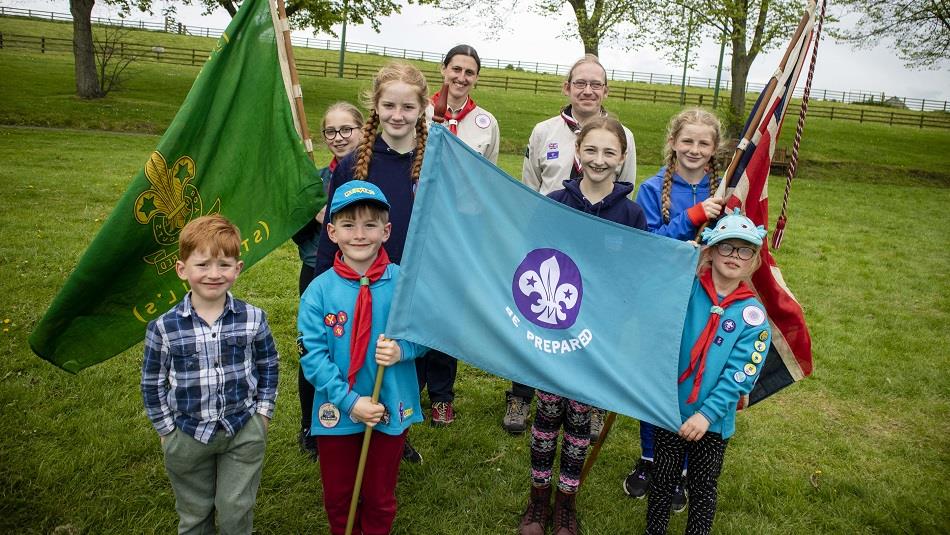 A group of scouts with flags at Beamish Museum.
