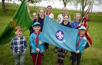 A group of scouts with flags at Beamish Museum.