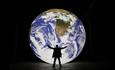 Large model of the earth with man standing in front.  Image credit: Natural Environment Research Council (NERC)

