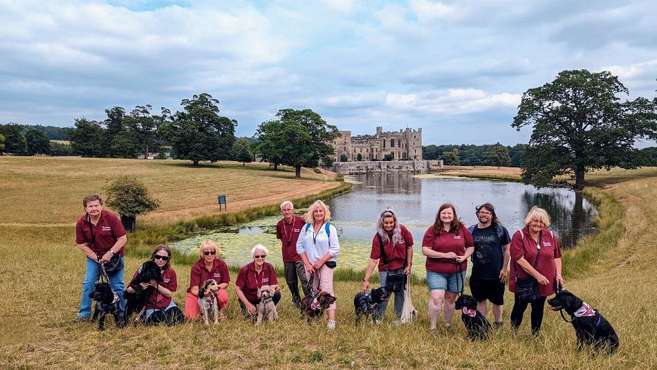 The Great British Dog Walk at Raby Castle.  Men and women with dogs in front of the lake and Raby Castle