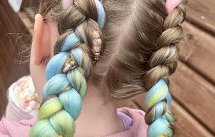 Multi coloured hair braiding.
