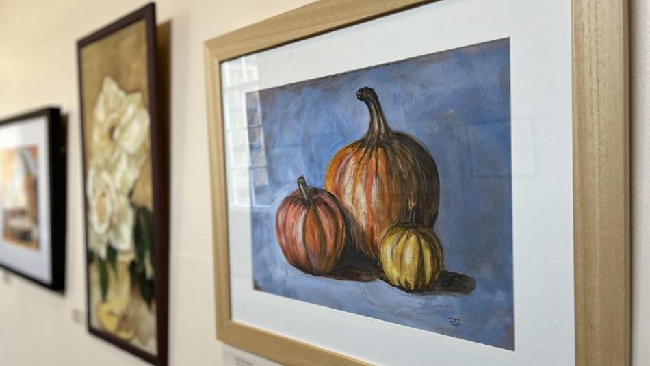 Image of colourful paintings of vegetables on the wall.