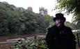 Andrew Ross (Tour guide) standing on the riverbanks at Durham with Durham Cathedral in the background
