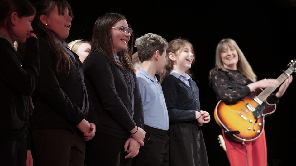Elaine Palmer performing with children from Acre Rigg Academy at The Lubetkin Theatre, East Durham College at a concert in January.