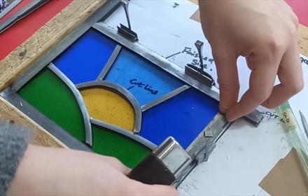 Someone working on their leaded stained glass art.