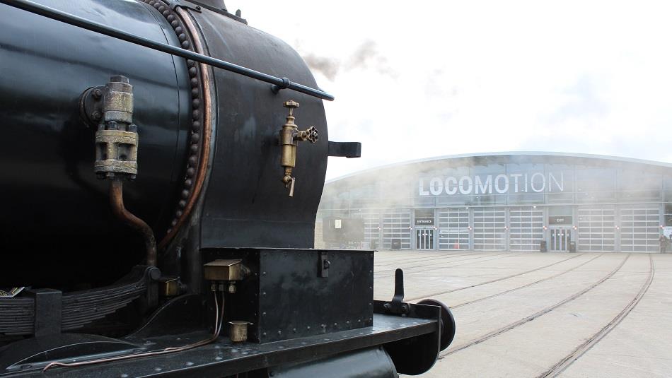 Steam train in front of the collections building at Locomotion