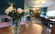 Image of a vase of flowers and a spacious stylish restaurant area at The Park Head Hotel.