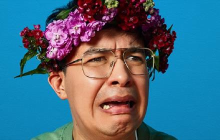 Image of Phil Wang wearing a floral headdress.