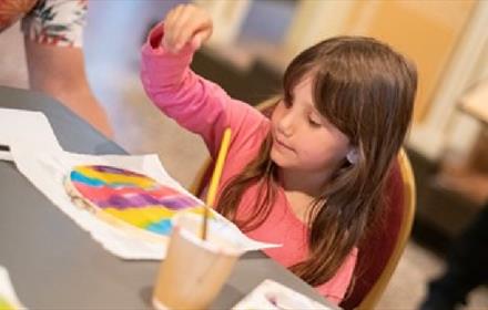 Image of a child enjoying arts and crafts activities at The Bowes Museum