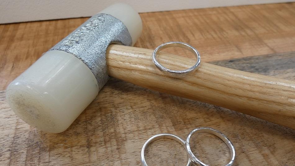 A jewellery making hammer with three silver rings