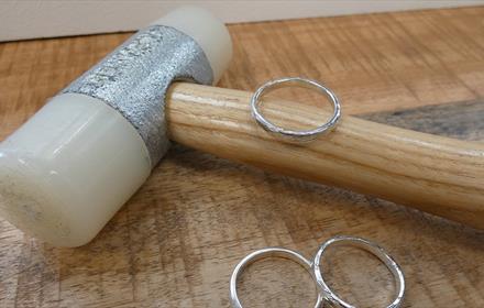 A jewellery making hammer with three silver rings