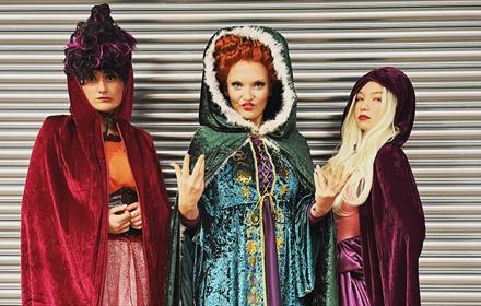 Image of three people dressed as the Sanderson Sisters from 'Hocus Pocus'.