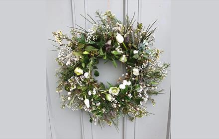 Wreath made with white spring flowers and greenery